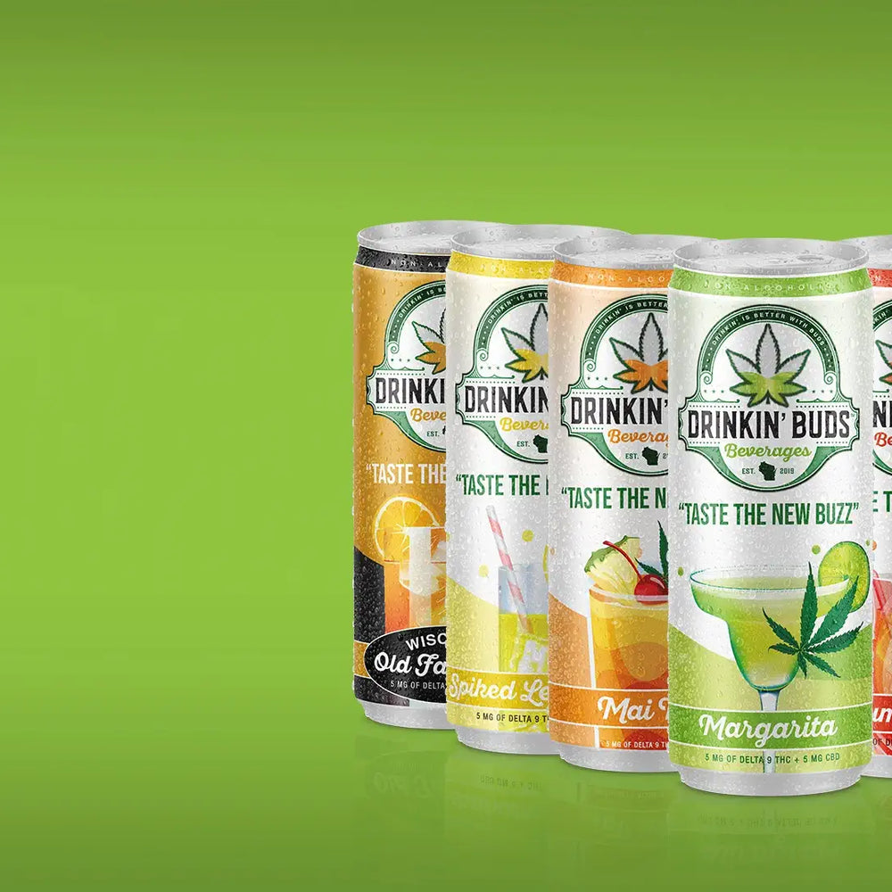 Four Drinkin' Buds beverage cans in a vibrant lineup, featuring flavors like Spiked Lemonade, Mai Tai, Margarita, and Rum Punch. Each can showcases cannabis leaf branding, promoting the tagline 'Taste the New Buzz,' with visible lime slices in the background for a zesty touch.