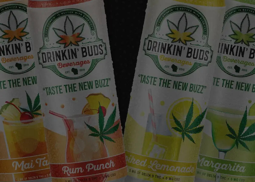 This image showcases four tall cans from the "Drinkin' Buds Beverages" lineup, emphasizing cannabis-infused cocktails. The flavors include Mai Tai, Rum Punch, Spiked Lemonade, and Margarita. Each can displays the slogan "Taste the New Buzz" alongside vibrant cocktail imagery and a cannabis leaf graphic. The labels note 5 mg of Delta-9 THC and 5 mg of CBD per can, promoting a fusion of familiar cocktail flavors with cannabis-infused relaxation.