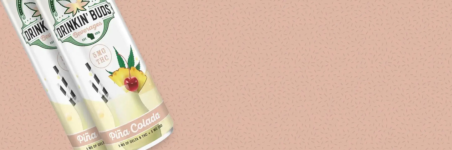Two cans of Drinkin Buds Piña Colada on a beige background